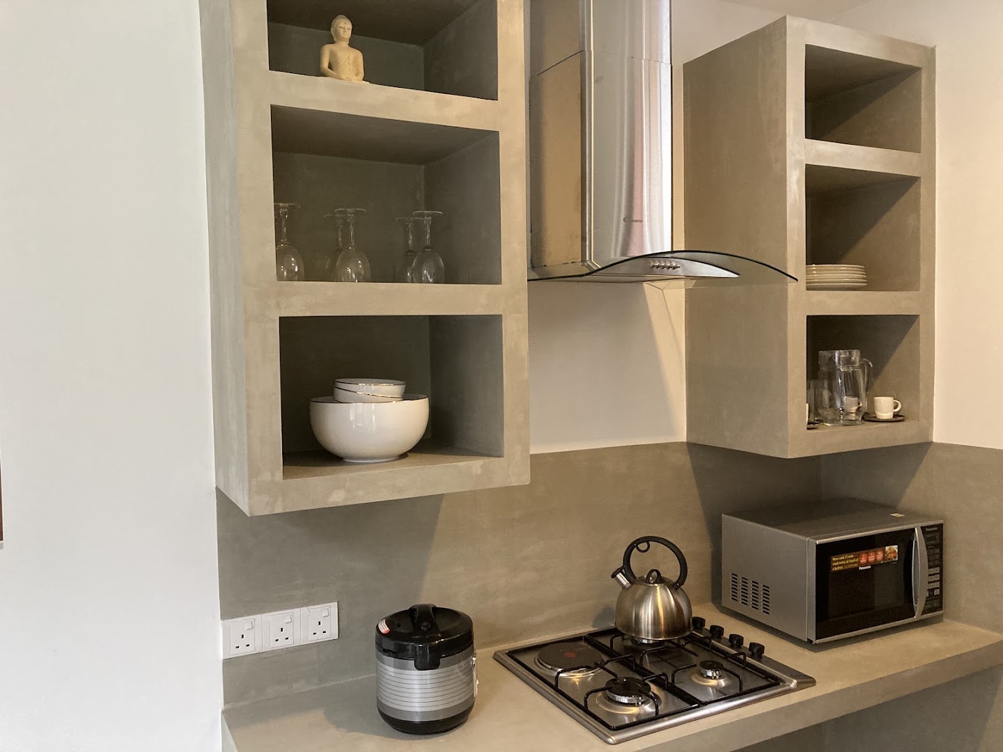 Villa kitchen with cooktop, microwave, kettle, and rice cooker