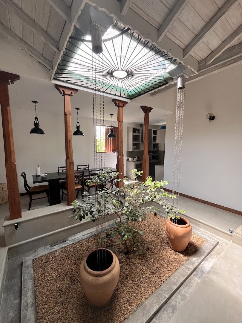 Skylit indoor garden with clay pots and timber columns